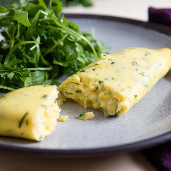 Spinach omelette with fresh greens on a plate
